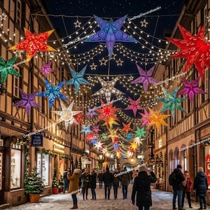 May include: A street scene at night featuring numerous illuminated star-shaped lanterns in various colors including red, blue, green, purple, and yellow, suspended above a pedestrian walkway between timber-framed buildings with shop windows.