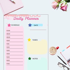 May include: A Daily Planner in pink and light blue, featuring sections for schedule, date, tasks, and notes. A pen, notebook, and coffee cup are also visible in the image.