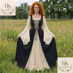 May include: A floor-length dress featuring a beige underlayer with a ruffled hem and a black overlayer with long, flared sleeves. The bodice includes a black lace-up corset-style front with decorative embroidery and off-the-shoulder sleeves.