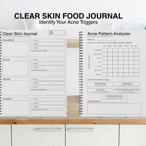 May include: A spiral-bound journal with the text "Clear Skin Food Journal" and "Identify Your Acne Triggers". The journal includes sections for tracking meals and an acne pattern analyzer.