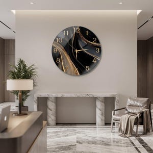 May include: A circular wall clock featuring a black and gold marbled pattern across its face. The clock has gold-coloured numerals from one to twelve and matching gold-coloured hour, minute, and second hands centred on the dial.
