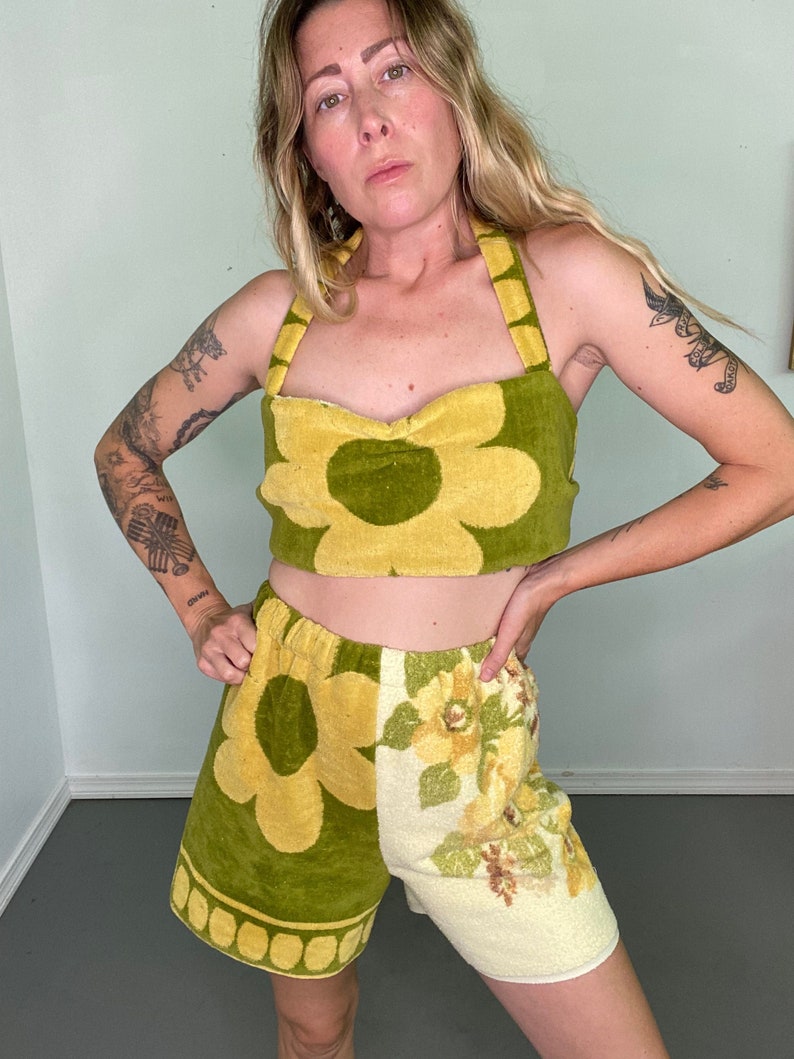 May include: A green and yellow floral print halter top and matching shorts set. The top has a sweetheart neckline and the shorts have a wide waistband.
