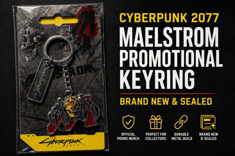 May include: Cyberpunk 2077 Maelstrom promotional keyring. The keyring features a metal design with red, black, and yellow accents. The keyring is attached to a silver chain and a rectangular tag. The packaging includes the text "Cyberpunk 2077".