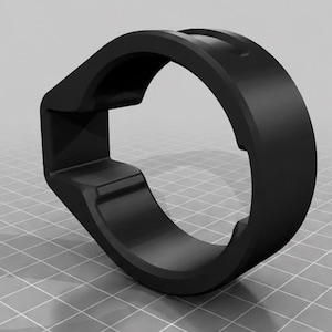 May include: A matte black, circular component featuring a distinct, angular protrusion on one side. The object has a smooth, uniform finish and a hollow center, with a geometric design that includes recessed sections along the inner and outer edges.