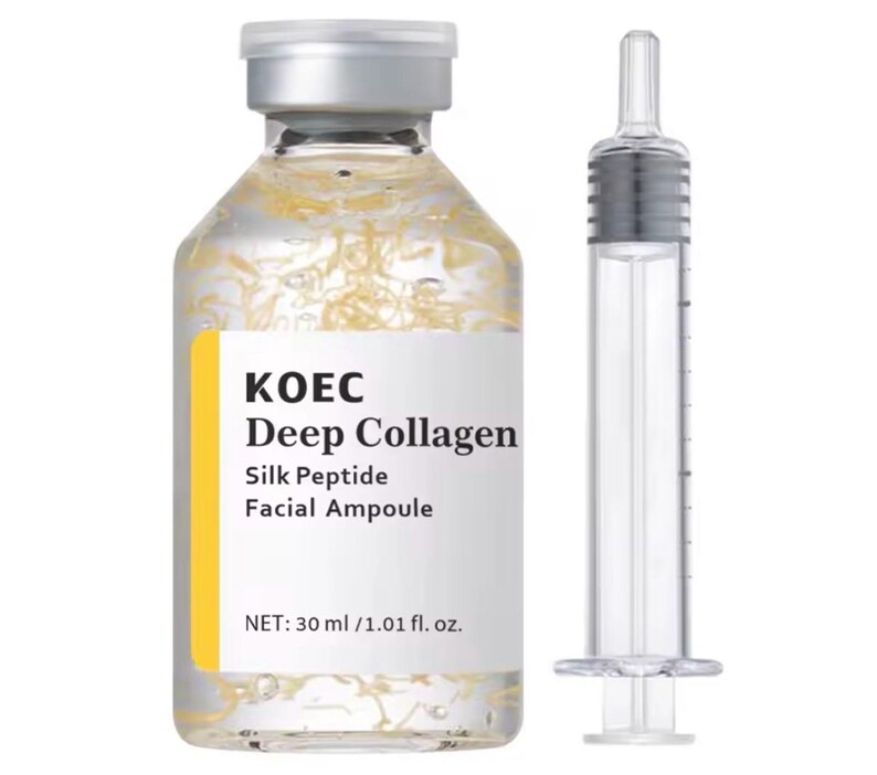 May include: A clear glass bottle of KOEC Deep Collagen facial ampoule with a silver cap and a yellow label. The bottle contains a clear liquid with strands of a yellow substance. A clear syringe is next to the bottle. The label reads "Silk Peptide Facial Ampoule".