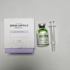 May include: A white box and a green serum bottle with a syringe. The box reads "ADVANCED SERUM AMPOULE STEM CELL" and "ANTI-AGING AMPOULE NATURAL STEM CELL COMPLEX". The bottle also reads "ADVANCED SERUM AMPOULE".