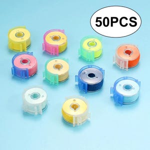 May include: A collection of sewing machine bobbins with colorful thread, each encased in a clear plastic holder. The set includes various thread colors such as yellow, pink, green, orange, blue, and white. The image features the text 50PCS.