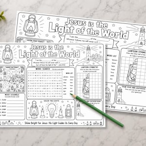 May include: Two black and white activity sheets with the text "Jesus is the Light of the World". One sheet features a word search, word scramble, and lantern symmetry activity. A green pencil rests on the sheets.
