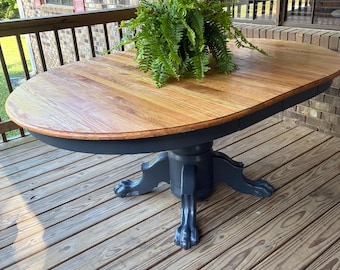 Single pedestal claw foot oak dining room table