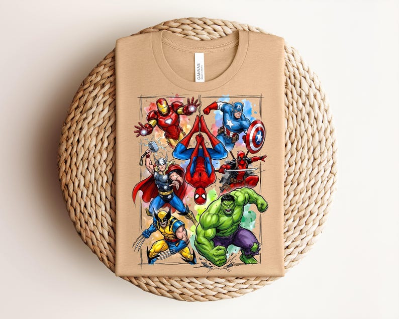 May include: A beige t-shirt with a vibrant illustration of Marvel superheroes, such as Iron Man, Captain America, Spider-Man, Deadpool, Hulk, Thor, and Wolverine. The design is framed with a watercolour-style border.