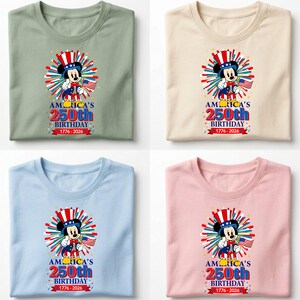 May include: Four t-shirts in different colors: sage green, cream, light blue, and pink. Each shirt features a graphic of a cartoon mouse in patriotic attire, holding a flag, with the text "America's 250th Birthday 1776-2026".