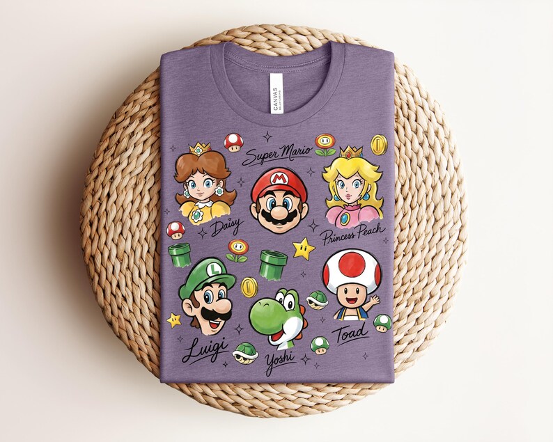 May include: A purple t-shirt featuring cartoon illustrations of Super Mario characters, including Mario, Luigi, Princess Peach, Daisy, Yoshi, and Toad. The words "Super Mario" and character names are written on the shirt.