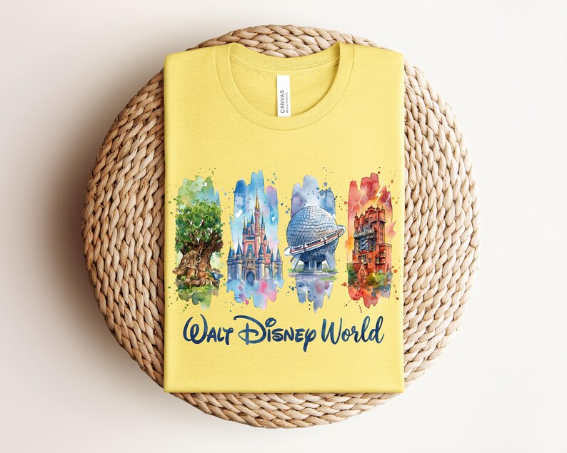 May include: Yellow t-shirt featuring watercolor illustrations of iconic Walt Disney World landmarks: the Tree of Life, Cinderella Castle, Spaceship Earth, and the Tower of Terror. The words "Walt Disney World" are printed in navy blue below the images.
