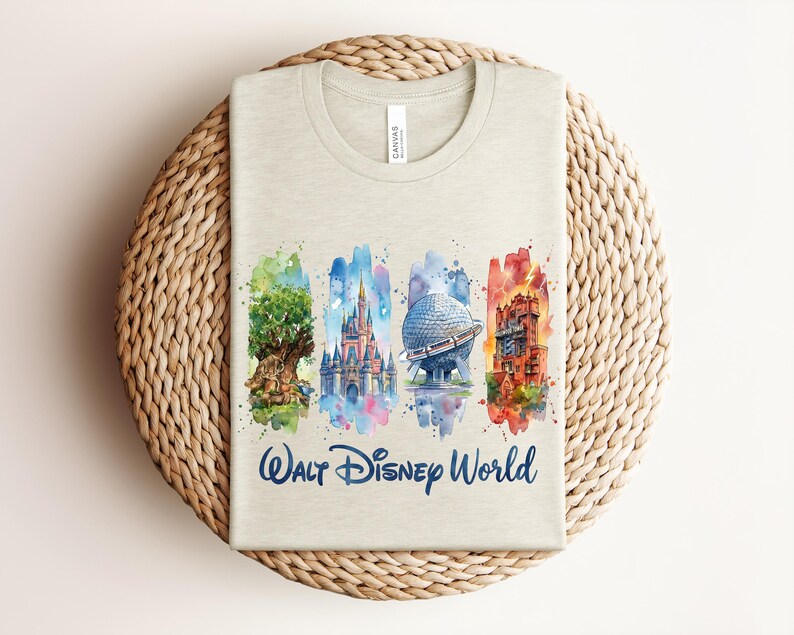 May include: A light beige t-shirt featuring a watercolor design of Walt Disney World landmarks. The design includes the Tree of Life, Cinderella Castle, Spaceship Earth, and the Tower of Terror, with "Walt Disney World" written below.