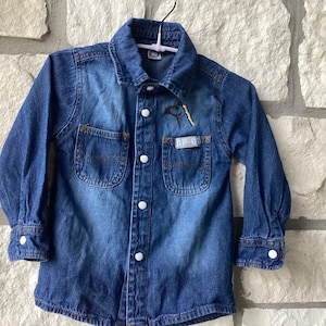 Child's lightweight Denim dress adorned by a western theme (3T). The piece has a hand embroidered horse, cowboy boot and a star.