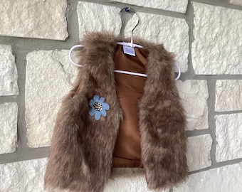 Child’s feau fur vest with flower accent ( child’s X small).