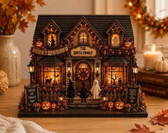 May include: A miniature Halloween-themed house with warm interior lighting, featuring a sign that reads THE SMITH FAMILY, a banner saying TRICK OR TREAT, and two signs reading TRICK OR TREAT and SPOOKY NIGHTS MAKE AN LIGHTS, with figures of a witch, child, and ghost.