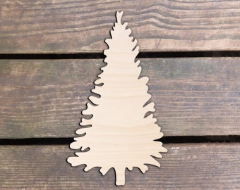 May include: A wooden cutout of a Christmas tree, with a simple, detailed design. The tree is light brown and is on a dark brown wooden background.