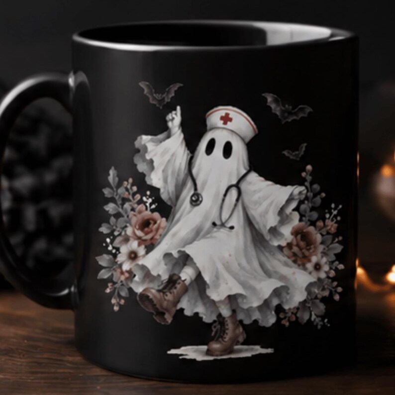 May include: A black ceramic mug featuring a graphic of a white ghost dressed as a nurse, complete with a stethoscope, a nurse cap with a red cross, and brown boots. The ghost is surrounded by floral accents and small bats on a dark background.