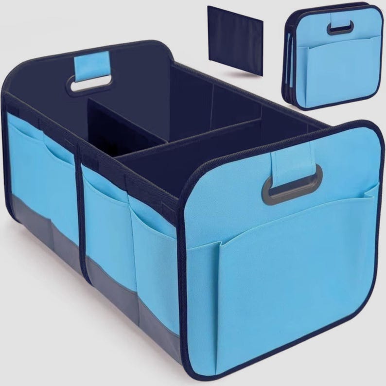 May include: A light blue car organiser with multiple compartments and pockets. The organiser has a dark blue interior and trim, with handles for easy carrying. It includes a separate, foldable panel and a smaller, matching organiser.