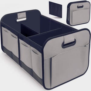May include: A grey and navy blue car organiser with multiple compartments and external pockets. The organiser has handles for easy carrying and is designed to keep items secure and organised. Includes a separate, foldable panel.