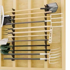 May include: A wooden wall-mounted garden tool organizer. It features a variety of tools, including shovels, rakes, and pitchforks, all neatly arranged. The tools have wooden handles and black or white heads. The organizer is made of light-colored wood.