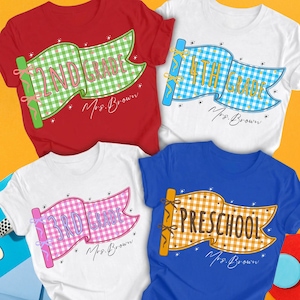 May include: Four t-shirts in red, white, blue, and white featuring gingham flag graphics. The shirts display text reading 2nd Grade, 4th Grade, 3rd Grade, and Preschool, along with the name Mrs. Brown written in a cursive script on each shirt.