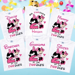 May include: Six white t-shirts featuring a graphic of Minnie Mouse, a large pink polka-dot number two, and text including Daddy, Mommy, Brother, Sister, Grandma, and Oh, Twodles Harper. The designs use pink and black lettering and accents.