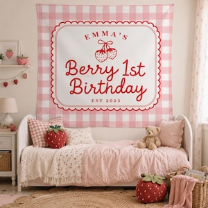 May include: A rectangular wall tapestry featuring a pink and white gingham pattern with a central white scalloped frame. The text reads Emma's Berry 1st Birthday EST 2025 in red, accompanied by a red strawberry illustration with a bow on top.