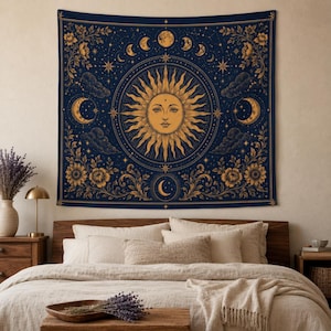 May include: A rectangular wall tapestry featuring a dark blue background with a central golden sun face surrounded by celestial motifs including moon phases, stars, and clouds. The design is framed by intricate golden floral and vine patterns.