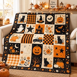 May include: A Halloween-themed patchwork quilt featuring a grid of squares with black, orange, and cream patterns. Designs include black cats, jack-o'-lanterns, ghosts, bats, a haunted house, stars, flowers, and checkered prints, finished with a floral border.