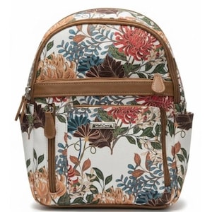 May include: A white backpack featuring a multi-colored floral print with red, orange, blue, and brown botanical patterns. The bag includes brown trim, multiple zippered compartments, side pockets, and a silver-toned logo plate on the front pocket.