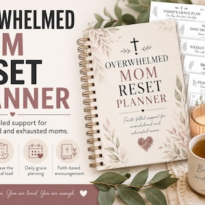 May include: A spiral-bound planner titled "Overwhelmed Mom Reset Planner" with the text "Faith-filled support for overwhelmed and exhausted moms." Includes a mug with "Be still and know" and a lit candle. Additional pages are visible.