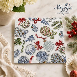 May include: A square paper napkin featuring a white background with a repeating pattern of blue and white chinoiserie-style ornaments, red bows, green ribbons, and small pagoda illustrations. The text Mizzy's NAPKIN SHOP is visible in the corner.