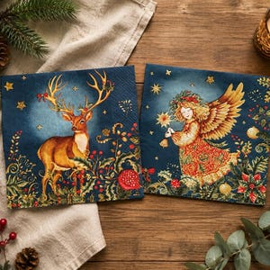 May include: Two square paper napkins featuring festive holiday illustrations on a dark blue background. One napkin displays a brown deer with large antlers, while the other shows an angel with golden wings holding a star, both surrounded by greenery.