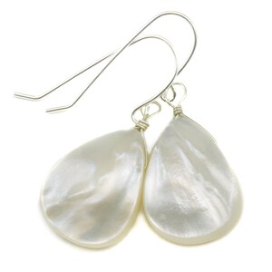May include: A pair of silver teardrop earrings with white mother of pearl drops.