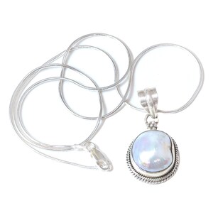 May include: A silver chain necklace with a silver pendant featuring a large, white pearl. The pearl is set in a silver frame with a decorative border.