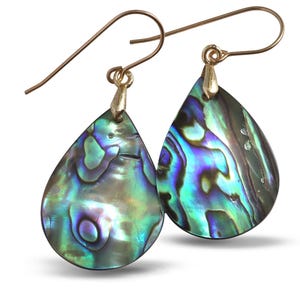 May include: A pair of teardrop-shaped earrings featuring iridescent abalone shell in shades of deep blue, vibrant green, and purple. Each shell piece is suspended from a simple gold-toned metal hook, showcasing a polished, reflective surface.