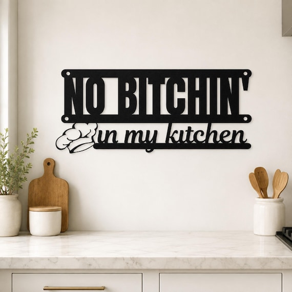 Hand-cut metal wall sign with a punchy 'No Bitchin' in My Kitchen' motto — the kind of bold, actual-craft piece that looks way better than a mass-printed sign.