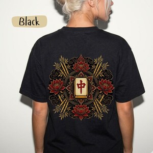 May include: Black t-shirt with a detailed back design. The design features a central Mahjong tile with Chinese characters, surrounded by red lotus flowers, bamboo stalks, and ornate patterns. The word "Black" is in a tan rectangle.