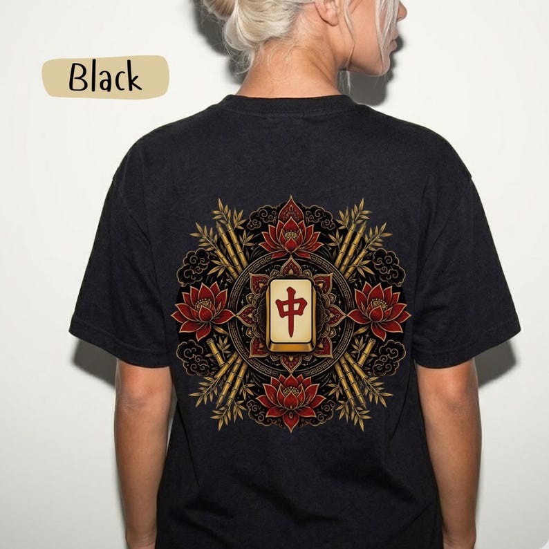 May include: Black t-shirt with a detailed back design. The design features a central Mahjong tile with Chinese characters, surrounded by red lotus flowers, bamboo stalks, and ornate patterns. The word "Black" is in a tan rectangle.