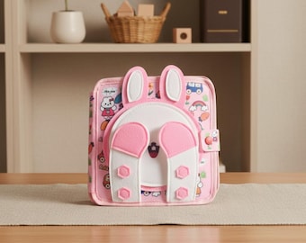 Libro tranquilo del conejito rosa Montessori para niños pequeños, juguete sensorial de fieltro, páginas educativas para desarrollar la motricidad fina.