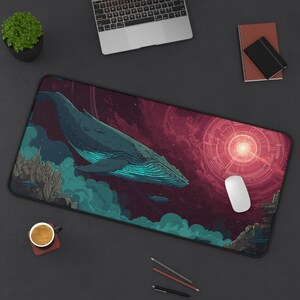 May include: A rectangular desk mat featuring a large blue whale swimming through a dark space-themed scene with teal clouds, rocky formations, and a glowing red circular portal. A white computer mouse rests on the right side of the mat surface.