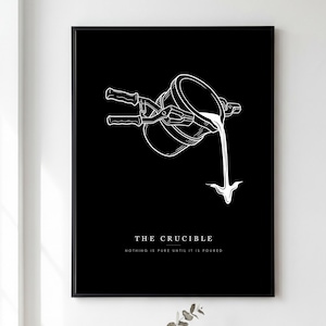 May include: A black and white framed wall art print featuring a line drawing of a crucible being tilted with tongs, pouring liquid downwards. The text reads THE CRUCIBLE and NOTHING IS PURE UNTIL IT IS POURED in a clean, white, sans-serif font.