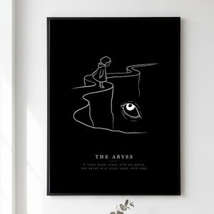 May include: A black framed wall art print featuring a white line drawing of a small hooded figure standing on the edge of a cliff. A large eye emerges from the darkness below. The text reads THE ABYSS and IF THOU GAZE LONG INTO AN ABYSS, THE ABYSS WILL ALSO GAZE INTO THEE.
