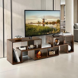 May include: A dark brown, modular TV stand with multiple open shelves and a flat top. The stand is made of wood and has a modern design. A flat-screen TV is placed on top, and decorative items are displayed on the shelves.