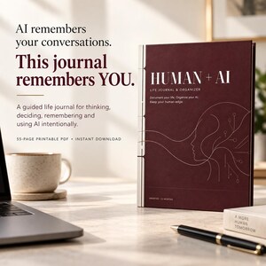 May include: A dark maroon journal titled HUMAN + AI LIFE JOURNAL & ORGANIZER with a white line art profile graphic. The cover text reads: Document your life. Organize your AI. Keep your human edge. Undated - 12 months. Includes 55-page printable PDF.