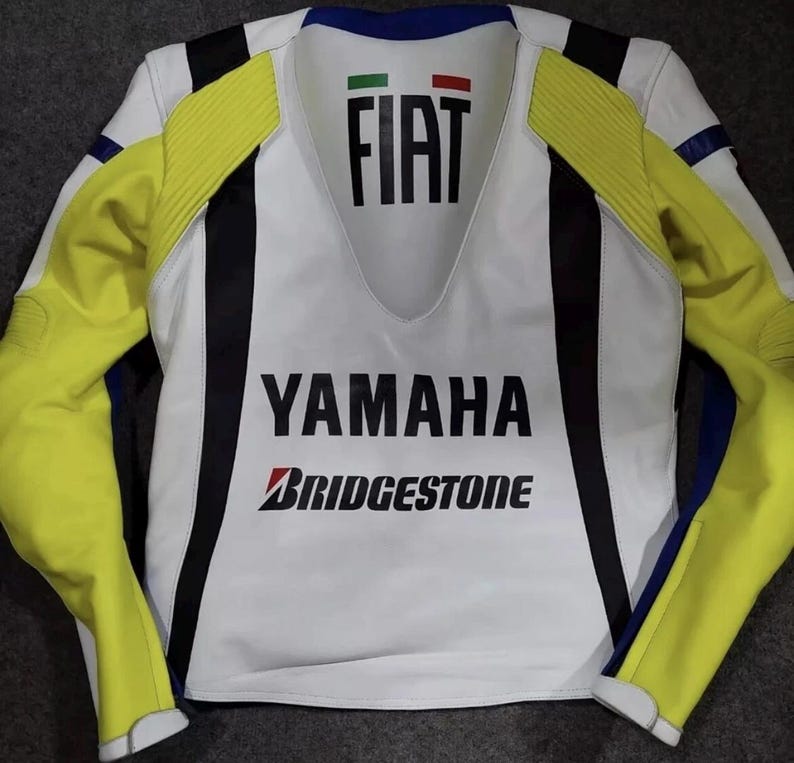 May include: A white, yellow, and black motorcycle jacket featuring the text FIAT with an Italian flag icon at the neckline, YAMAHA in large black letters across the chest, and the Bridgestone logo printed below in black and red lettering.
