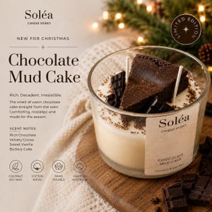 May include: A clear glass candle jar labelled Soléa Candle Studio Chocolate Mud Cake, filled with cream-coloured wax topped with a dark brown cake-shaped wax piece, chocolate squares, and sprinkles, featuring two white cotton wicks.