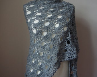May include: A grey crocheted shawl with a lacy pattern. The shawl is draped over a white dress form.